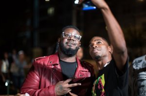 T-Pain, left, takes a photo with a fan following the 2015 BET Hip Hop Awards, Friday, Oct. 9, 2015, at the Atlanta Civic Center in Atlanta. (AP Photo/Branden Camp)