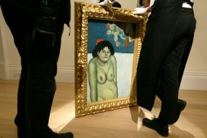 Members of Sotheby's staff pose for the media with "La Gommeuse" by Pablo Picasso at the Sotheby's auction house in London, Friday Oct. 9, 2015. It will be auctioned at Sotheby's New York Impressionist and Modern Art Evening sale on November 3. (AP Photo/Tim Ireland)