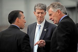 BrightFarms CEO Paul Lightfoot, left, meets Virginia Agriculture and Forestry Secretary Todd Haymore, center, and Gov. Terry McAuliffe at the greenhouse farm in the Elkwood  area of Culpeper county, Va. on Tuesday, Oct. 13, 2015. BrightFarms is investing $7.35 million to build two new greenhouses. Governor McAuliffe approved a $75,000 grant from the Fund to assist with the project, which Culpeper County is matching with $75,000 in local grant funds. (Peter Cihelka/The Free Lance-Star via AP) MANDATORY CREDIT