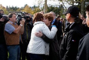 Premier of British Columbia Christy Clark hugs Tofino Mayor Josie Osborne following a news conference in Tofino, British Columbia,Tuesday, Oct. 27, 2015. Investigators are trying to unravel the mystery of what caused a whale watching boat to capsize off Vancouver Island on Sunday, killing multiple people. (Chad Hipolito/The Canadian Press via AP) MANDATORY CREDIT