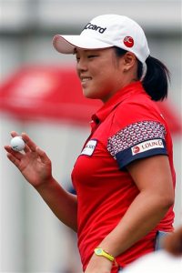 Ha Na Jang of South Korea gestures after sinking a birdie on the eighteenth hole during the second round of the LPGA Malaysia golf tournament at Kuala Lumpur Golf and Country Club in Kuala Lumpur, Malaysia, Friday, Oct. 9, 2015.(AP Photo/Joshua Paul)