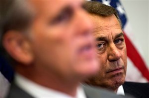 In this Oct. 7, 2015, photo, outgoing House Speaker John Boehner of Ohio listens at right as House Majority Leader Kevin McCarthy of Calif., speaks during a new conference on Capitol Hill in Washington. Boehner wants out. He really does. But the Ohio House Republican is staying put, for now _ and that could improve the chances for a debt limit increase by early next month to avoid a market-shattering government default and possibly a bipartisan budget deal to head off a government shutdown in December. Conservative hardliners have already forced Boehner to announce hes leaving and then caused further chaos by blocking the ascension of McCarthy. (AP Photo/Evan Vucci)