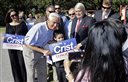 Former Republican Florida Gov. Charlie Crist, second from left, poses with supporters before holding a news conference to announce that he is running for Congress as a Democrat Tuesday, Oct. 20, 2015, in St. Petersburg, Fla. Looking on is Crist's wife Carole, left. (AP Photo/Chris O'Meara)