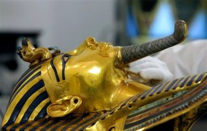 German restorer Christian Eckmann examines the beard of the famed golden mask of King Tutankhamun as an Egyptian-German team begins restoration work over a year after the beard was accidentally broken off and hastily glued back with epoxy, at the Egyptian Museum in Cairo, Egypt, Tuesday, Oct. 20, 2015. The 3,300-year-old burial pharaonic mask was discovered in Tutankhamun's tomb along with other artifacts by British archeologists in 1922, sparking worldwide interest in archaeology and ancient Egypt. (AP Photo/Amr Nabil)