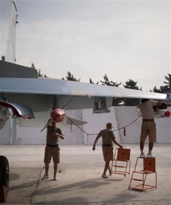 In this photo taken on Thursday, Oct.  22, 2015, Ground crew prepare a fighter jet for a combat mission at Hemeimeem airbase, Syria. Nearly a quarter of a century after the Soviet collapse, the air campaign in Syria has proven that the resurgent Russian military machine could again operate far away from the nation's borders. (AP Photo/Vladimir Isachenkov)