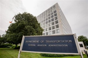 In this photo taken June 19, 2015, the Transportation Department's Federal Aviation Administration (FAA) building in Washington. The FAA proposed a record $1.9 million fine Tuesday against an aerial photography company for flying drones in crowded New York and Chicago airspace without permission. (AP Photo/Andrew Harnik)