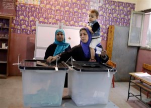An Egyptian voter casts her vote at polling station during the first round of parliamentary elections, in Giza, Cairo, Egypt, Sunday, Oct. 18, 2015. (AP Photo/Amr Nabil)
