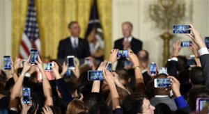 President Barack Obama, left, standing with Vice President Joe Biden, right, speaks at a reception in the East Room of the White House in Washington, Thursday, Oct. 15, 2015, for Hispanic Heritage Month and the 25th anniversary of the White House Initiative on Educational Excellence for Hispanics. (AP Photo/Susan Walsh)