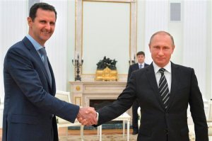 In this photo taken on Tuesday, Oct. 20, 2015, Russian President Vladimir Putin, right, shakes hand with Syria President Bashar Assad in the Kremlin in Moscow, Russia.  Assad has traveled to Moscow in his first known trip abroad since the war broke out in Syria in 2011 to meet his strongest ally Russian leader Vladimir Putin, Syrian and Russian media reported Wednesday. (Alexei Druzhinin, RIA-Novosti,  Kremlin Pool Photo via AP)