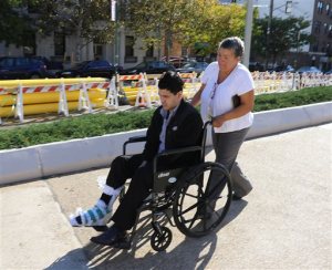 Suspended Linden, N.J., Police Officer Pedro Abad is pushed toward the courthouse in a wheelchair in the Staten Island borough of New York, Thursday, Oct. 29, 2015, for an appearance on drunken driving charges. During the proceedings, Abads attorney said his client may have been drugged at a strip club before crashing head-on into a tractor-trailer on March 20, 2015. The accident killed two of his passengers and injured a third. (Anthony DePrimo/Staten Island Advance, via AP) NO SALES,  TV OUT,  MAGS OUT, NYC LOCALS OUT; MANDATORY CREDIT