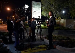 Members of the media stand outside Sunrise Hospital and Medical Center while waiting for word about Lamar Odom on Tuesday, Oct. 13, 2015, in Las Vegas. Odom, a former NBA basketball player, was hospitalized after he was found unconscious at a Nevada brothel, authorities said. (AP Photo/David Becker)