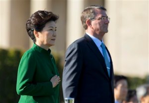 South Korean President Park Geun-hye with Defense Secretary Ash Carter, puts her hand over her heart as the South Korean national anthem is played during a full military honors parade to welcome her, Thursday, Oct. 15, 2015, at the Pentagon. South Korean President Park Geun-hye is walking a fine line as she looks to strengthen her nation's alliances with both the United States and China.     (AP Photo/Manuel Balce Ceneta)