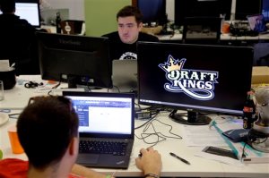 FILE- In this Sept. 9, 2015, file photo, Len Don Diego, marketing manager for content at DraftKings, a daily fantasy sports company, works at his station at the company's offices in Boston. New York's attorney general has sent letters to daily fantasy sports websites DraftKings and FanDuel demanding they turn over details of any investigations into their employees on Tuesday, Oct. 6, 2015. (AP Photo/Stephan Savoia, File)