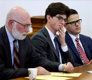Owen Labrie, center, listens to a recorded statement from his victim with his lawyer J.W. Carney, left, and Sam Zaganjoir before being sentenced in Merrimack County Superior Court Thursday, Oct. 29, 2015, in Concord, N.H. The graduate of the exclusive St. Pauls School was sentenced to a year in jail for sexually assaulting a 15-year-old freshman girl as part of a tradition in which upperclassmen competed to rack up sexual conquests. Labrie was allowed to remain free on bail while he appeals his conviction. (AP Photo/Jim Cole, Pool)