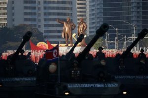 Statues of Kim Il Sung and Kim Jong Il stand above soldiers during a military parade in Pyongyang, North Korea, Saturday, Oct. 10, 2015. North Korean leader Kim Jong Un declared Saturday that his country was ready to stand up to any threat posed by the United States as he spoke at a lavish military parade to mark the 70th anniversary of the North's ruling party and trumpet his third-generation leadership. (AP Photo/Wong Maye-E)