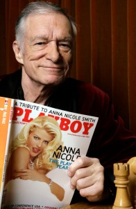 FILE - In this April 5, 2007 file photo, Playboy Enterprises founder Hugh Hefner poses with a copy of Playboy magazine featuring Anna Nicole Smith as Playmate of the Year, at the Playboy Mansion in Los Angeles. The magazine that helped usher in the sexual revolution in the 1950s and '60s by bringing nudity into America's living rooms announced this week that it will no longer run photos of completely naked women. Starting in March, 2016, Playboy's print edition will still feature women in provocative poses, but they will no longer be fully nude. (AP Photo/Damian Dovarganes, File)