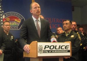 Albuquerque Mayor Richard Berry, surrounded by federal officials and members of the local law enforcement community, as expresses grief over the death of Albuquerque police officer Daniel Webster during a news conference, Thursday, Oct. 29, 2015, at police headquarters in Albuquerque, N.M. Webster, 47, an eight-year police veteran, was shot outside a pharmacy last week during a traffic stop and died Thursday. (AP Photo/Mary Hudetz)