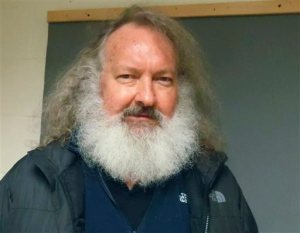 FILE - In this Oct. 9, 2015 file photo provided by the Vermont State Police, actor Randy Quaid stands in the Vermont State Police barracks in St. Albans, Vt. In a hearing Monday, Oct. 12, 2015 in St. Albans, Quaid was ordered held on $500,000 bail on charges that he skipped out of the country five years ago after being charged with vandalism in California. Quaid and his wife Evi Quaid were detained at the Canadian border Friday night while trying to re-enter the United States after Canadian officials granted Evi Quaid citizenship but denied Randy Quaid permanent residence and said he would be deported. Evi Quaid was in court Monday in Burlington, where she also was ordered held on $500,000 bail. (Vermont State Police via AP, File)