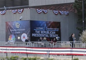 A security officer and fencing block off the entrance to the banner-strewn Coors Events Center, the venue for the Oct. 28 Republican presidential debate, Tuesday, Oct. 27, 2015, at CU Boulder, Colo. Republican presidential candidates taking the debate stage Wednesday in Colorado are hoping to carry momentum from a 2014 U.S. Senate victory in this toss-up state where independent voters outnumber the electorate from both major parties. (AP Photo/Brennan Linsley)