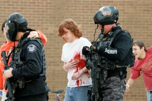 FILE - In this file photo taken Jan. 5, 2009, during a mock shooter exercise at Bowling Green State University in Bowling Green, Ohio, participants portraying victims are led to a triage unit. A 2015 review by The Associated Press finds that eight years after the Virginia Tech massacre led to tighter security at U.S. colleges, some schools make "active shooter" training mandatory for incoming students, and Ohio takes a hands-off approach by leaving policies up to schools to develop. (J.D. Pooley/Sentinel-Tribune via AP, File) MANDATORY CREDIT; TOLEDO BLADE OUT