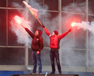 Demonstrators hold torches and wave the Polish flag during the annual march commemorating Poland's National Independence Day in Warsaw, Poland, Wednesday, Nov. 11, 2015. The march Wednesday was organized by several radical far-right organizations under the anti migrant slogan Poland for Poles. Poles for Poland". (AP Photo/Czarek Sokolowski)