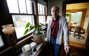Former Iowa State University employee Dennis Smith, of Des Moines, Iowa, stands in his home, Tuesday, Nov. 17, 2015, in Des Moines, Iowa. Iowa State last year paid $650,000 to settle Smiths lawsuit alleging he was retaliated against by superiors, including subjected to a lengthy threat assessment investigation. The case is one example of the challenges facing university threat assessment teams, which were formed on many campuses after the 2007 Virginia Tech massacre. (AP Photo/Charlie Neibergall)