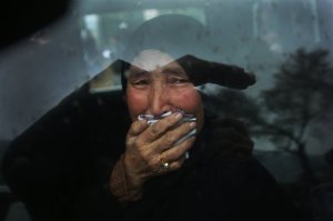 A Hazara tribeswoman cries in a car as thousands march through the Afghan capital of Kabul on Wednesday, Nov. 11, 2015, carrying the coffins of seven ethnic Hazaras who were allegedly killed by the Taliban and calling for a new government that can ensure security in the country. (AP Photos/Massoud Hossaini)