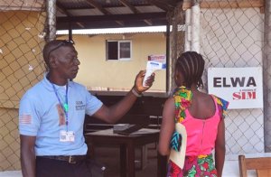 A unidentified family member, right, of a 10-year old boy that contracted Ebola, has her temperature  measured by a health worker before entering the Ebola clinic were the child is being treated on the outskirts of Monrovia, Liberia, Friday, Nov. 20, 2015. Health authorities are reporting one confirmed Ebola case, a 10-year boy who is currently being attended to at the treatment center on the outskirts of Monrovia, the capital.(AP Photo/ Abbas Dulleh)