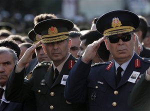 Turkey's Land Forces Commander Gen. Salih Zeki Colak, left, and Air Forces Commander Gen. Abidin Unal attend funeral prayers for Lt. Col. Ihsan Ejdar, 43, a Turkish army officer killed in a Kurdish rebel attack at Turkey-Iraq border on Saturday, at the Kocatepe Mosque in Ankara, Turkey, Sunday, Oct. 18, 2015. Terrorism and the violence has rocked southeastern Turkey since the resumption of fighting between the military and the Kurdistan Workers' Party, or PKK. The separatist group is considered a terror organization by the Turkey, the U.S. and the EU.(AP Photo/Burhan Ozbilici)