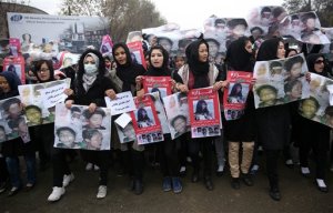 Women march in the Afghan capital of Kabul on Wednesday, Nov. 11, 2015 with pictures showing ethnic Hazaras who were allegedly killed by the Taliban, calling for a new government that can ensure security in the country. Farsi posters carried by the protesters call for security ant call on Preident Ashraf Ghani to resign.(AP Photos/Massoud Hossaini)