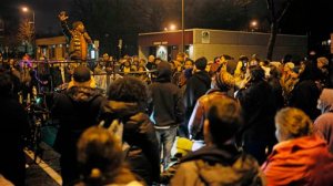 Protesters including pastor Danny Givens demanded answers over the shooting of Jamar Clark near a police precinct in Minneapolis, Tuesday, Nov. 17, 2015. State investigators looking into the fatal shooting of Clark by police during a scuffle have several partial videos of the incident but won't release them at this time, despite demands from protesters, an official said Tuesday. (Richard Tsong-Taatarii/Star Tribune via AP)  MANDATORY CREDIT; ST. PAUL PIONEER PRESS OUT; MAGS OUT; TWIN CITIES LOCAL TELEVISION OUT