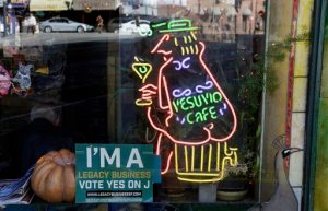 In this photo taken Thursday, Oct. 29, 2015, an election sign supporting the historic preservation of legacy business is seen in the window of the Vesuvio Cafe in San Francisco. San Francisco voters will decide Tuesday whether to restrict Airbnb operations in the city, impose a freeze on luxury housing in the Mission and approve a $310 million bond for affordable housing. They will also vote on whether to retain Mayor Ed Lee, probably yes as he faces no real competition, but could boot out the sheriff. The saloon dates to 1948 and was a regular hangout to Jack Kerouac and other Beat poets. (AP Photo/Eric Risberg)
