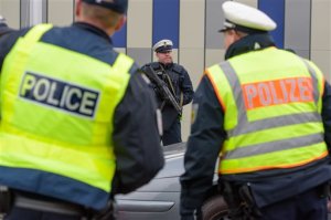 French, left, and German police control   cars  at the French-German border  near Saarbruecken, southwestern Germany, Sunday Nov. 15, 2015.  Multiple attacks across Paris on Friday night have left scores dead and hundreds injured.  ( (Oliver Dietze/dpa via AP)