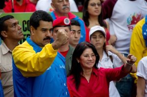FILE - In this Oct. 18, 2014 file photo, Venezuela's President Nicolas Maduro and first lady Cilia Flores, greet supporters as they arrive for a march for peace in Caracas, Venezuela. Two nephews of Venezuela's powerful first lady Cilia Flores were arrested in Haiti on charges of conspiring to smuggle 800 kilograms of cocaine into the U.S. and will be arraigned in New York, three people familiar with the case said Wednesday, Nov. 11, 2015. (AP Photo/Fernando Llano, File)