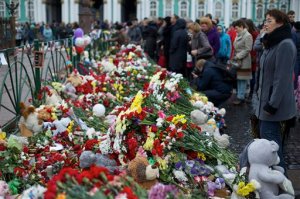 People gathered to lay flowers in memory of the plane crash victims at Dvortsovaya (Palace) Square in St.Petersburg, Russia, on Wednesday, Nov. 4, 2015. A Russian official says families have identified the bodies of 33 victims killed in Saturday's plane crash over Egypt. The Russian jet crashed over the Sinai Peninsula early Saturday, killing all 224 people on board, most of them were holidaymakers. (AP Photo/Ivan Sekretarev)