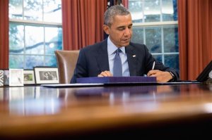 President Barack Obama signs H.R. 1314, the "Bipartisan Budget Act of 2015," Monday, Nov. 2, 2015, in the Oval Office in the White House in Washington, before traveling Andrews Air Force Base, Md., on his way to Newark, N.J. Obama will spend the day highlighting the re-entry process of formerly incarcerated individuals back into society. (AP Photo/Andrew Harnik)