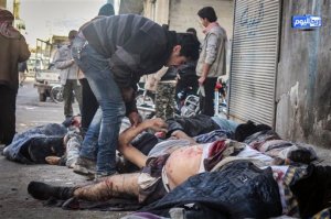 In this photo provided by the Syrian anti-government activist group Ariha Today, which has been authenticated based on its contents and other AP reporting, a Syrian man tries to identify victims after airstrikes believed to be carried out by Russian warplanes in the center of Ariha town in the northwestern province of Idlib, Syria, Sunday, Nov. 29, 2015. Syrian opposition media is reporting that airstrikes believed to be carried out by Russian warplanes have killed and wounded dozens of people in a northwestern Syrian market. (Ariha Today via AP)