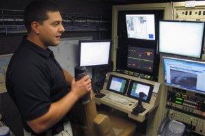 In this Nov. 3, 2015, photo, Steve Bodin, a pilot for the U.S. Customs and Border Protection's Air and Marine Operations at Grand Forks Air Force Base, N.D., looks over the controls and keyboards used to fly the Predator drone. Bodin spends about 60 to 70 percent of his time flying unmanned aircraft for CBP, although he prefers to be in the air. (AP Photo/Dave Kolpack)