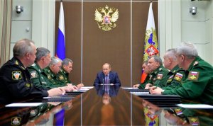 FILE In this Tuesday, Nov. 10, 2015 file photo Russian President Vladimir Putin, centre, chairs a meeting with defense officials in the Bocharov Ruchei residence in the Black Sea resort of Sochi, Russia. President Vladimir Putin's spokesman said plans for a new submarine-launched nuclear torpedo shown on Kremlin-controlled television were secret and should never have been aired. NTV and Channel One showed a large document  filmed over a military officer's shoulder during a meeting with Putin  with drawings and details of a weapons system called Status-6.  (Alexei Druzhinin/RIA Novosti, Kremlin Pool Photo via AP)