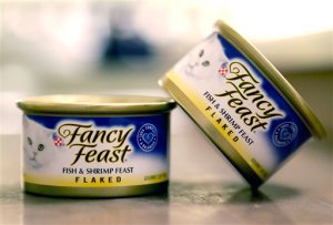 This Monday, Nov. 16, 2015, photo shows Fancy Feast cat food, fish and shrimp feast flavor, a product of Thailand, purchased at a Publix market in Orlando, Fla. A report commissioned by Nestle SA found that impoverished migrant workers in Thailand are sold or lured by false promises and forced to catch and process fish that ends up in the global food giants supply chains. Nestle is not a major purchaser of seafood in Southeast Asia but does some business in Thailand, primarily for its Purina brand Fancy Feast cat food. (AP Photo/John Raoux)