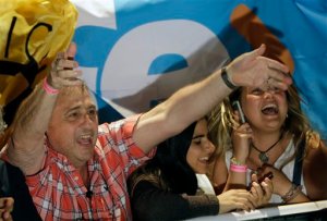 Supporters of opposition presidential candidate Mauricio Macri cheer as they wait for official results in Buenos Aires, Argentina, Sunday, Nov. 22, 2015. Argentines are choosing between opposition leader Mauricio Macri and President Cristina Fernandez' chosen successor Daniel Scioli in Sunday's runoff election. According to exit polls reported by local television channels, Macri is ahead in the vote count.(AP Photo/Ricardo Mazalan)