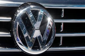 FILE - In this Sept. 22, 2015, file photo, the Volkswagen logo of a car is photographed during a car show in Frankfurt, Germany. A dealer familiar with Volkswagen's plans says the automaker intends to offer $1,000 in gift cards and vouchers to owners of smaller diesel cars as a gesture of goodwill to owners with 2-liter four-cylinder diesel engines that have been implicated in an emissions cheating scandal. (AP Photo/Michael Probst, File)