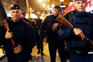 French police patrol at the place de la Republique in Paris, France, Sunday Nov. 15, 2015, two days  after over 120 people were killed  in a series of shooting and explosions.  French troops deployed around Paris on Sunday and tourist sites stood shuttered in one of the most visited cities on Earth while investigators questioned the relatives of a suspected suicide bomber involved in the country's deadliest violence since World War II.(AP Photo/Jerome Delay)