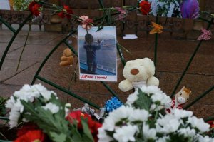 A portrait of 10 month Darina Gromova, a victim of a plane crash, is surrounded by flowers and toys attached to a fence at Dvortsovaya (Palace) Square in St.Petersburg, Russia, Wednesday, Nov. 4, 2015. A Russian official says families have identified the bodies of 33 victims killed in Saturday's plane crash over Egypt. The Russian jet crashed over the Sinai Peninsula early Saturday, killing all 224 people on board. Most of them were holidaymakers from Russia's St. Petersburg. (AP Photo/Ivan Sekretarev)