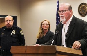 Canon City Police Chief Paul Schultz, left, and Crime Prevention Coordinator Jen O'Connor listen as Superintendent George Welsh talks about a sexting scandal at Canon City High School during a news conference in Canon City, Colo., on Friday, Nov. 6, 2015. An unspecified number of students have been suspended and the school forfeited its final football game of the season because of the number of players involved. (Tracy Harmon/The Pueblo Chieftain via AP)