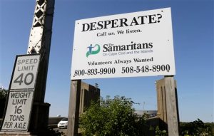 CORRECTS TO SAY THE BOSTON ORGANIZATION IS USING TEXT MESSAGING, NOT THE CAPE COD ORGANIZATION, WHOSE SIGN IS DEPICTED - In this Thursday, Oct. 8, 2015 photo, a sign for The Samaritans on Cape Cod and the Islands is posted near the Bourne Bridge, in Bourne, Mass. For decades Samaritans have offered phone counseling to the desperate and distraught. But increasingly Samaritans, Inc., based in Boston, is turning to text messaging to engage with young people. (AP Photo/Steven Senne)