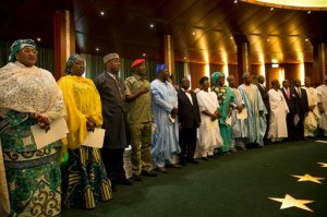 Nigeria newly sworn in ministers sing  Nigeria national anthem at swearing in ceremony at the presidential villa  in Abuja, Nigeria, Wednesday, Nov. 11, 2015. Nigerian President Muhammadu Buhari belatedly swore in a Cabinet on Wednesday that puts a woman investment banker in charge of finance as Africas biggest economy is squeezed by halved petroleum prices. (AP Photo)
