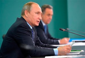Russian President Vladimir Putin, left, and Sports Minister Vitaly Mutko, attend their late-night meeting with the heads of Russia's sports federations in the Black Sea resort of Sochi, Russia, Wednesday, Nov. 11, 2015. Putin has ordered an investigation into allegations of widespread doping among the countrys sports figures. (Alexei Druzhinin, RIA-Novosti,  Kremlin Pool Photo via AP)