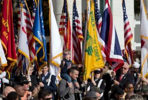Honor guards carry the colors as they are retired at the conclusion of the annual National Veterans Day commemoration, Wednesday, Nov. 11, 2015, at Arlington National Cemetery in Arlington, Va., attended by President Barack Obama. (AP Photo/Manuel Balce Ceneta)