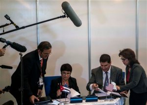 President of Sprint Corporation Marcelo Claure, second from right, and Cuba's Director of Mobile Services of Cuban company ETECSA Hilda Arias, second from left, sign an agreement for cell phone roaming service at the 33rd Havana International Fair (FIHAV) in Havana, Cuba, Monday, Nov. 2, 2015. The agreement will allow Sprint subscribers visiting Cuba to send and receive calls and text messages directly through the state company Etecsa, which has the monopoly for telecommunications service on the island. (AP Photo/Ramon Espinosa)